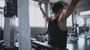 Spor konsepti. Genç adam titreme ile ağırlığını kaldırıyor