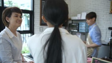 Kahve dükkanı konsepti. Kadın müşteri, zevkten dört köşe olmuş gibi kahve içiyor. 4k Çözünürlüğü.