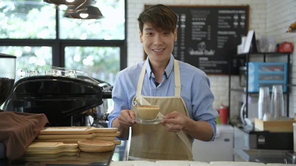 Concepto cafetería. El camarero está haciendo café con una sonrisa — Foto de Stock