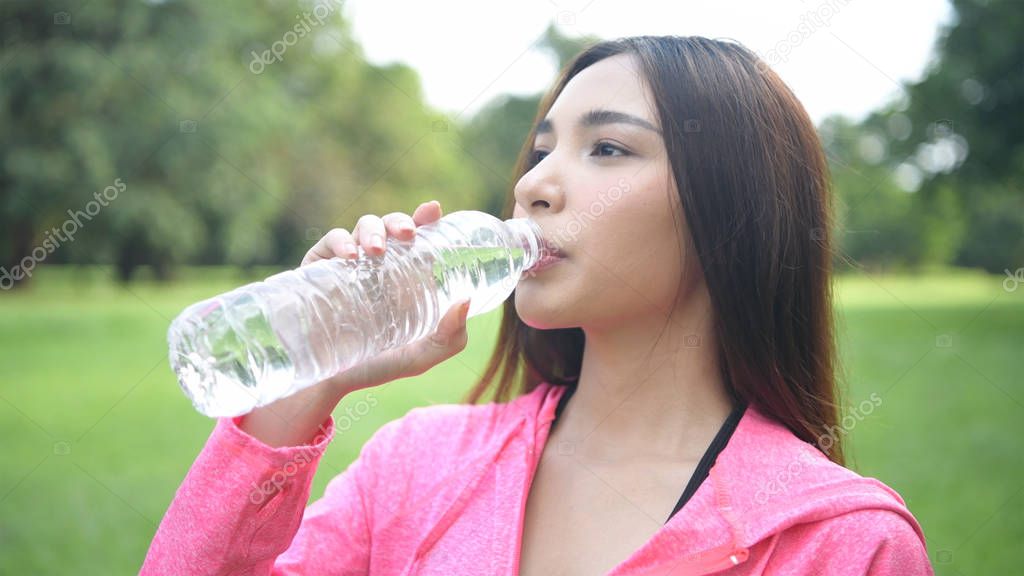 Exercise concepts. Beautiful women are drinking water with fresh