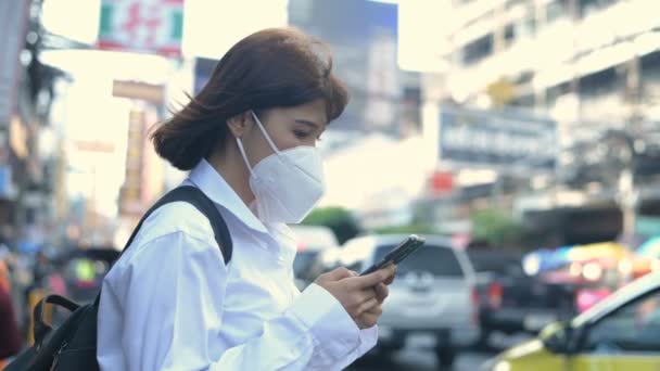 Concept of pollution prevention. Woman playing with mobile phone on roadside. 4k Resolution. — Stock Video