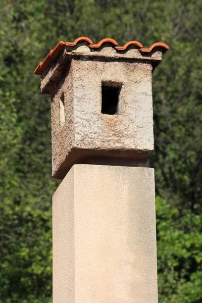 Luxusní Betonový Komín Červenými Střešní Dlaždicemi Nahoře Obklopený Hustými Stromy — Stock fotografie