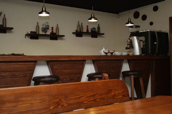 cafe interior design with bar and wooden chairs. the decor on the wall