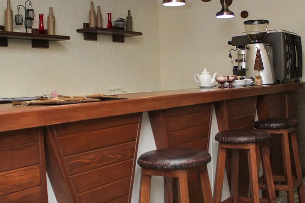 cafe interior design with bar and wooden chairs. the decor on the wall