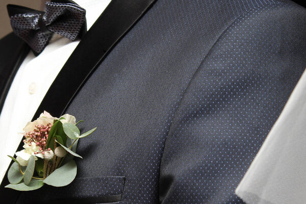 bouquet in the pocket of the groom's jacket at the wedding