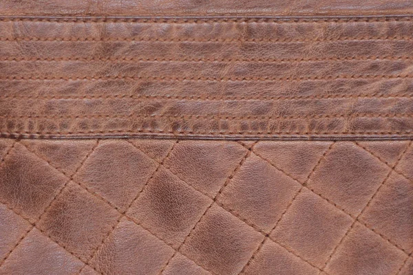 Fondo marrón de cuero textura puntada. viejo, desgastado — Foto de Stock