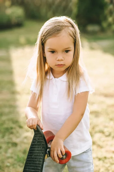 Portrait Adorable Little Child Skateboard Hands Yard — Free Stock Photo