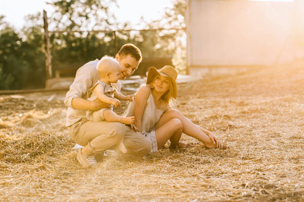 family with adorable son spending time together at countryside