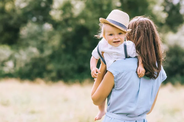 Stylish Mother Holding Baby Boy Hands Walking Field — Stock Photo, Image