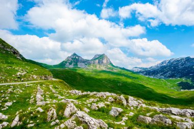 rocky mountains and blue cloudy sky in Durmitor massif, Montenegro clipart