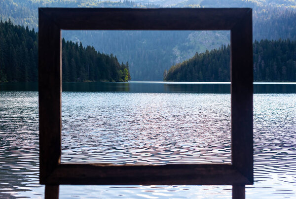 view through frame on beautiful glacial Black Lake in Montenegro