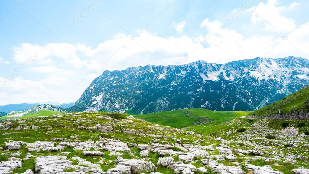 panoramic view of green valley with stones in Durmitor massif, Montenegro