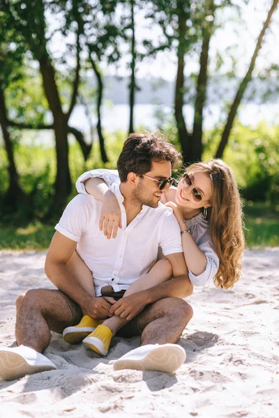 Girlfriend hugging handsome boyfriend on sandy city beach — Stock Photo
