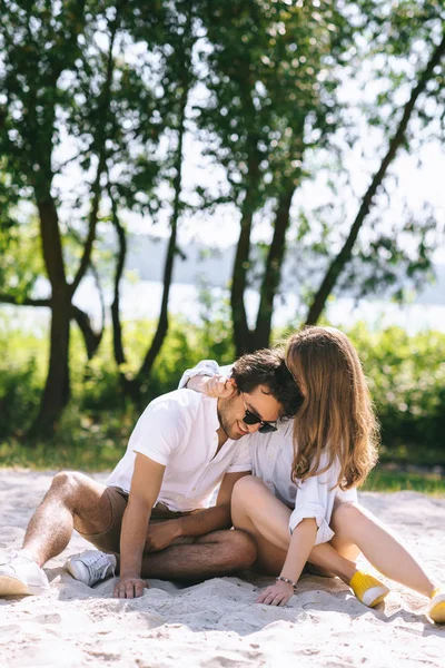 Girlfriend hugging boyfriend on sandy city beach — Stock Photo