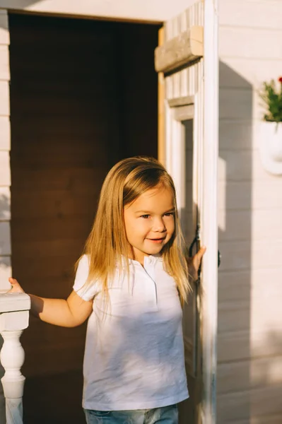 Portrait of little kid standing on porch on summer day — Stock Photo