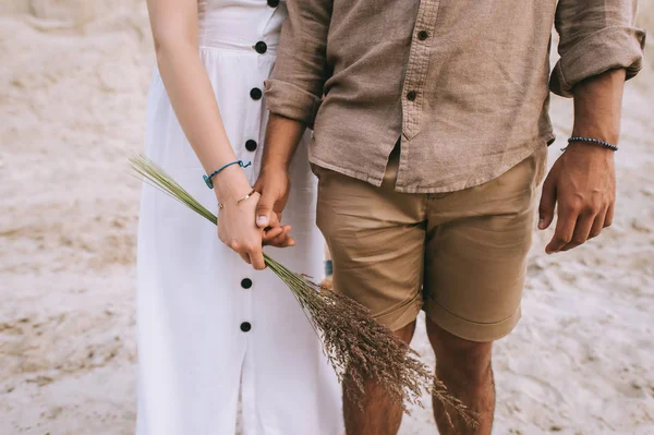 Cropped view of stylish couple holding hands — Stock Photo