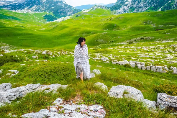 Beautiful woman walking in blanket on valley in Durmitor massif, Montenegro — Stock Photo
