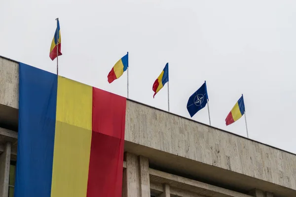 Bandeiras romenas e da OTAN ao vento — Fotografia de Stock