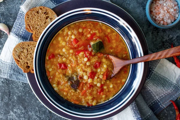 Delicious homemade soup from organic red lentil, vegetables, basil, garlic and piece of black bread — Stock Image Delicious Homemade Soup Organic Red Lentil Vegetables Basil Garlic Piece Stock Picture