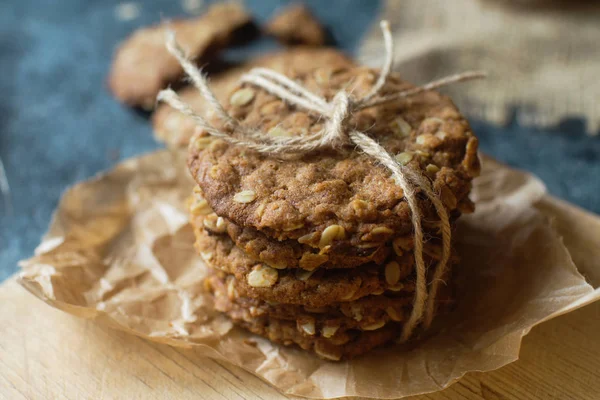 Homemade oatmeal fitness cookies on wooden board and dark stone talbe