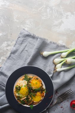 Kiraz domates, soğan ve baharat rustik tarzı ile plaka üzerinde kızarmış yumurta. Besleyici organik kahvaltı, sağlıklı yaşam, üstten görünüm, metin için yer