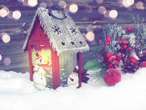 lantern with lit candle light christmas winter greeting card with snow on background