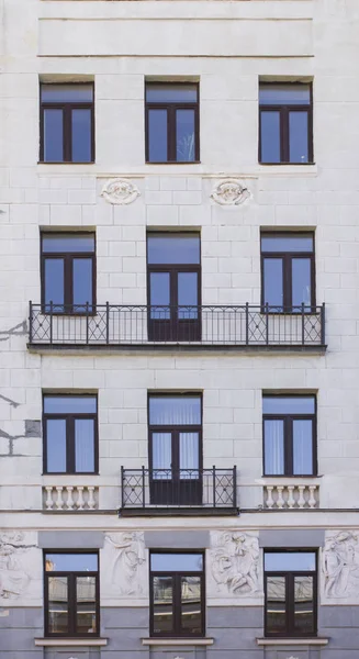 Vintage architecture classical facade residential building is prepared for repair. Front view.