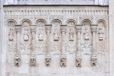 Exterior architectural decorations  St. Demetrius Cathedral, Vladimir, Russia. White stone carving on south wall of the church. Arcature belt clipart