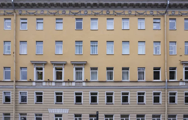 Vintage architecture classical facade in Empire style with military garlands and laurel wreaths front view