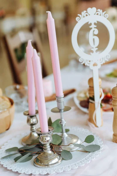 Candlesticks with candles on the table.