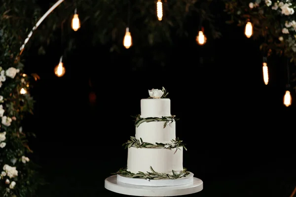 Pastel de boda minimalista de tres niveles en el fondo de las luces. Pastel en la boda — Foto de Stock