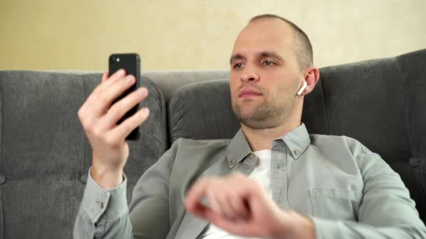 Homem relaxante em seu apartamento ouvindo uma música — Vídeo de Stock