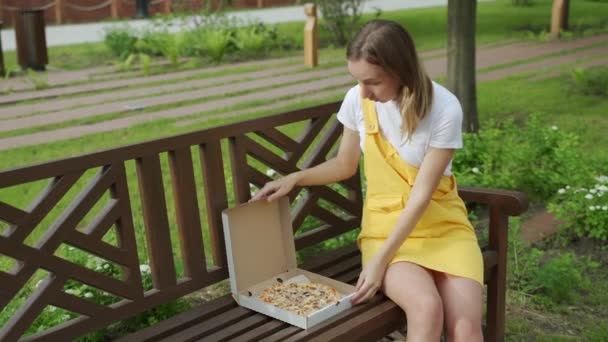 Kobieta je pizzę na ulicy — Wideo stockowe