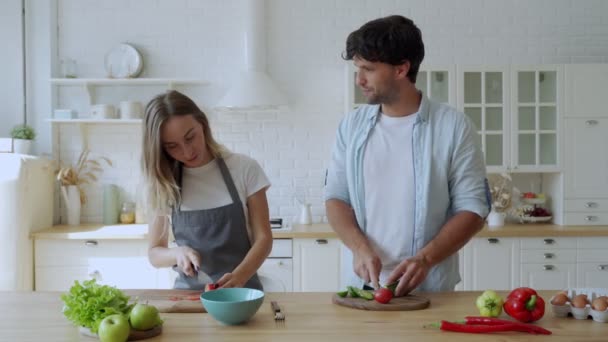 Fiatal boldog pár élvezi és elkészíti az egészséges étel a konyhában — Stock videók