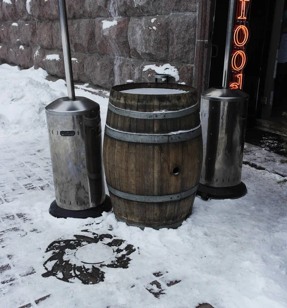barrels of wood stand for drinks in the cafe in the winter