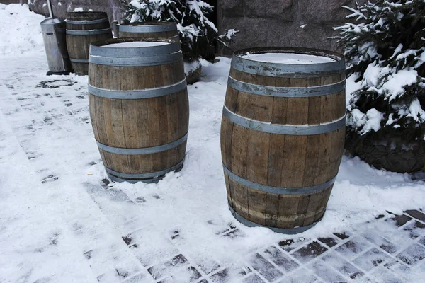 barrels of wood stand for drinks in the cafe in the winter