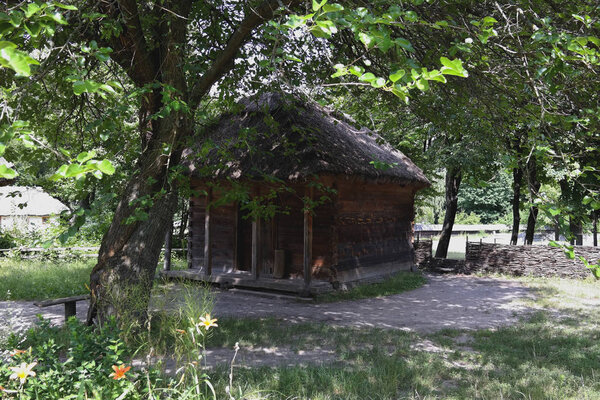 Old Ukrainian house. Ukrainian hut of the nineteenth century. Summer landscape, sunshine. Village Pirogovo.