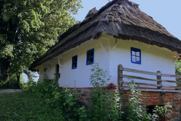 Old Ukrainian house. Ukrainian hut of the nineteenth century. Summer landscape, sunshine. Village Pirogovo.