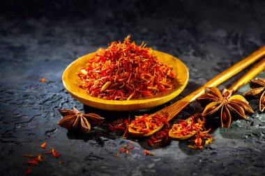Saffron. Various Indian Spices on black stone table. Spice and h clipart