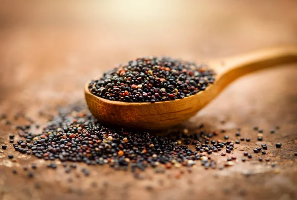 Quinoa. Zwarte korrels in een houten lepel. Gluten vrij gezond eten — Stockfoto