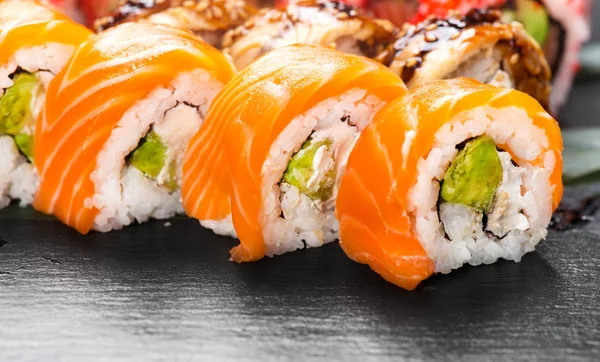 Sushi rolls closeup. Japanese food in restaurant. Roll with salm — Stock Photo, Image