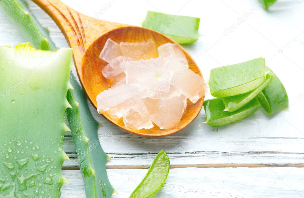 Aloe Vera gel closeup on white wooden background. Organic sliced