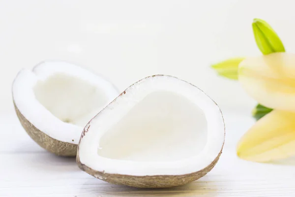 Natural herbal skin care products, top view ingredients coconut, essence oil and flower concept of the best all natural face moisturizer. Facial treatment preparation background