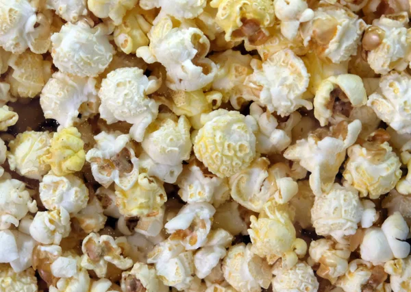 Classic sweet popcorn close-up. Background in the shop window in the cinema.