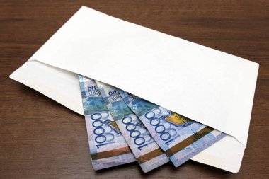 Yolsuzluk ve Kazakistan'ın hukukun ihlali kavramı. Kazkh para banknot beyaz bir zarf içinde masaya yalan. Otuz bin tenge bir hediye ya da rüşvet için hazırlanıyor.