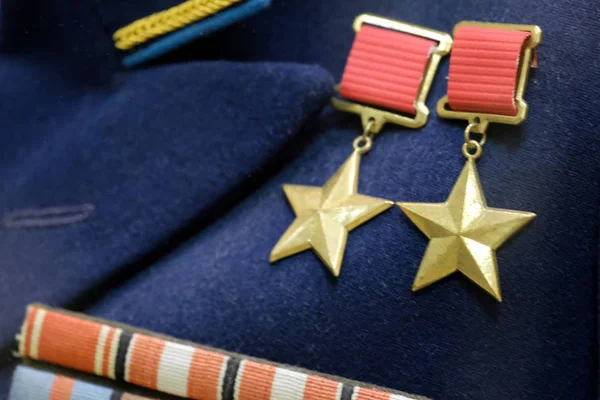 Shallow depth of field. Medals on the blue uniform of the times of the Great Patriotic War. The symbol of the highest degree of distinction between the warrior of the USSR: twice the hero of the Soviet Union.