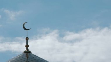 Üç kuş Müslüman Camii üst üzerinde uçmak. Bulutlar gökyüzü bir minare üzerinde hilal bir close-up.