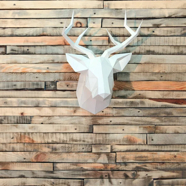 Paper deer head on the wall of wooden bars. Designer background for decoration in the room. Square picture. New Year\'s wall decoration.