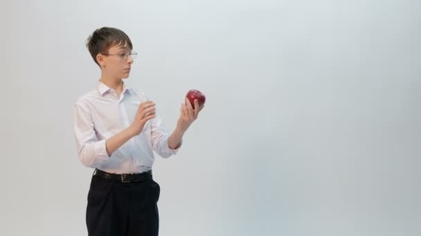 Teenager Examines Sniffs Red Apple Young Man Student Schoolboy Funny — Stock Video