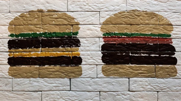 白いレンガの壁に描かれた つのハンバーガー チーズバーガーやサンドイッチ カフェやファーストフード レストラン広告用装飾 — ストック写真